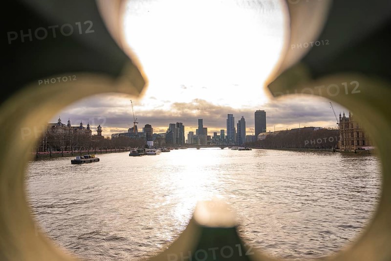 View of a river at sunset through an architectural opening, London, England, Great Britain