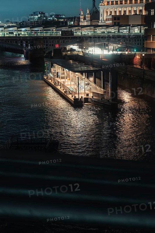 Nocturnal river landscape with illuminated bridges and buildings in the city, London, England, Great Britain