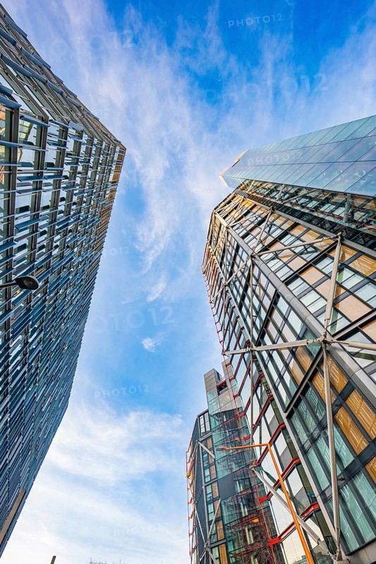 View between two modern skyscrapers in the blue sky, London, England, Great Britain