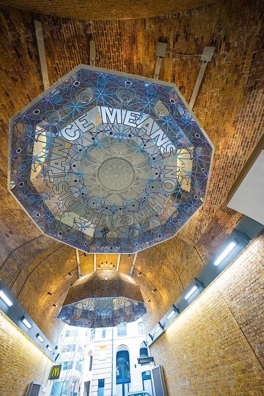 Brick vault with artistic ceiling motif and lettering in a modern urban space, London, United Kingdom