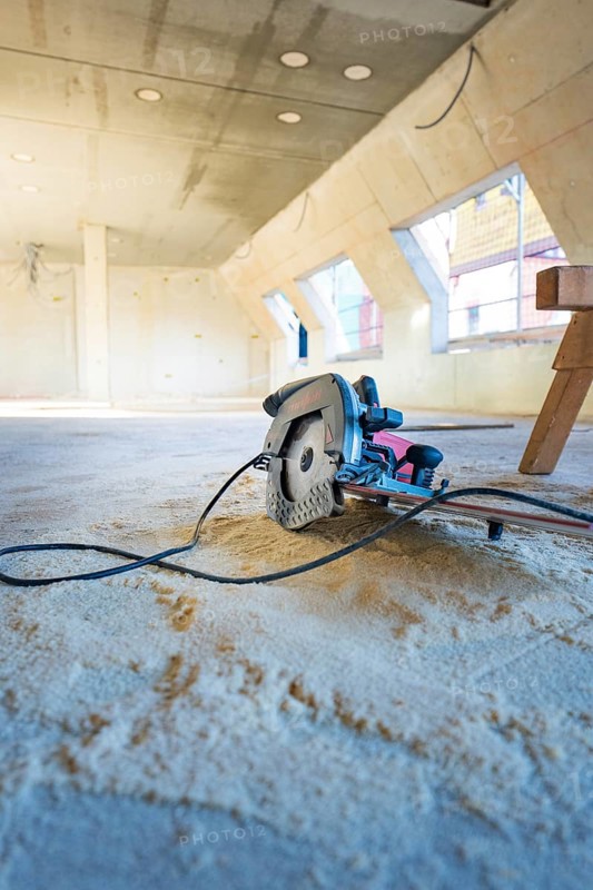 Interior with construction site, a saw lying on the ground under bright light, carpentry, renovation, roof extension, Stuttgart, Germany