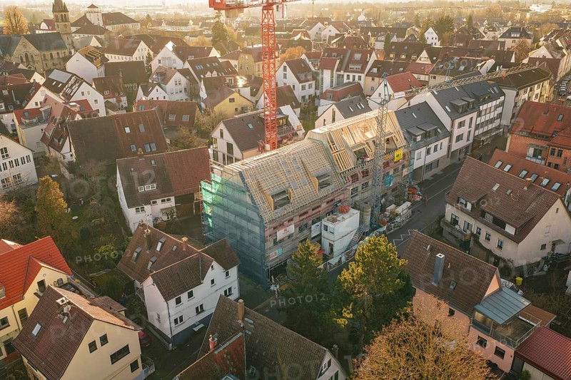 Aerial view of an urban residential area with a visible construction site and a crane, carpentry, renovation, roof extension, Stuttgart, Germany