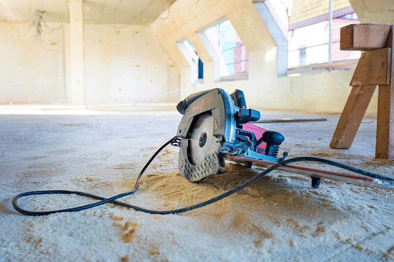Interior of a construction site with a saw on the ground, carpentry, renovation, roof extension, Stuttgart, Germany