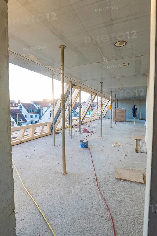 Unfinished interior of a construction site with a view of the residential area, construction site of a carpentry workshop, roof extension, renovation, Stuttgart, Germany