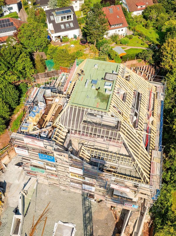Aerial view of a construction site in a residential area with progressive building construction, construction site of a carpentry workshop, roof extension, renovation, Stuttgart, Germany
