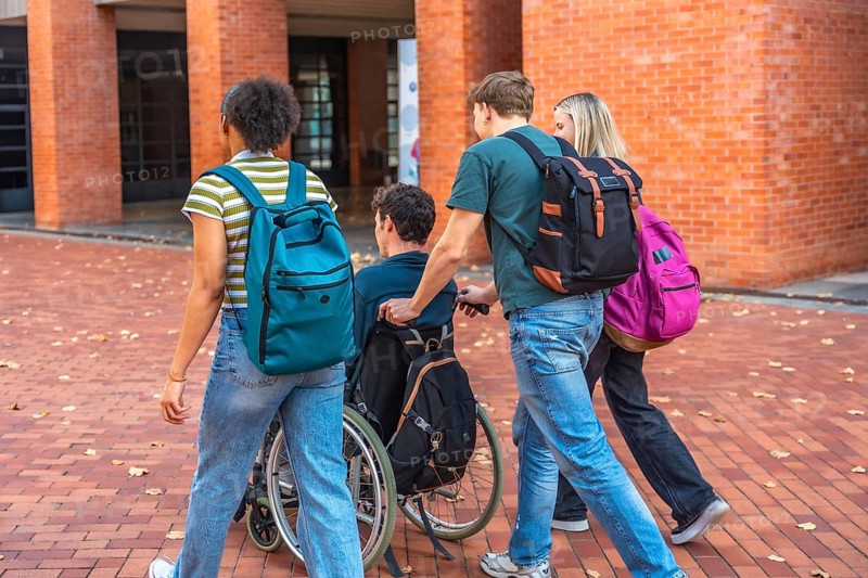 University students walking together with a classmate using a wheelchair, showing friendship and inclusion on campus, promoting diversity and accessibility in education