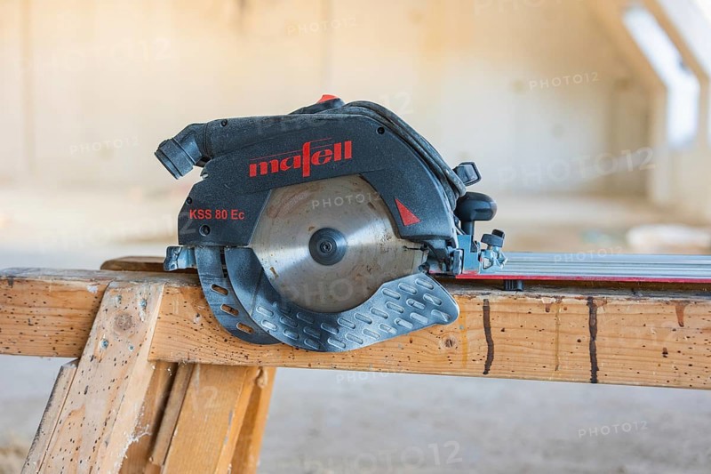 Close-up of a black and red circular saw on a wooden table, carpentry construction, roof extension, renovation, Stuttgart, Germany