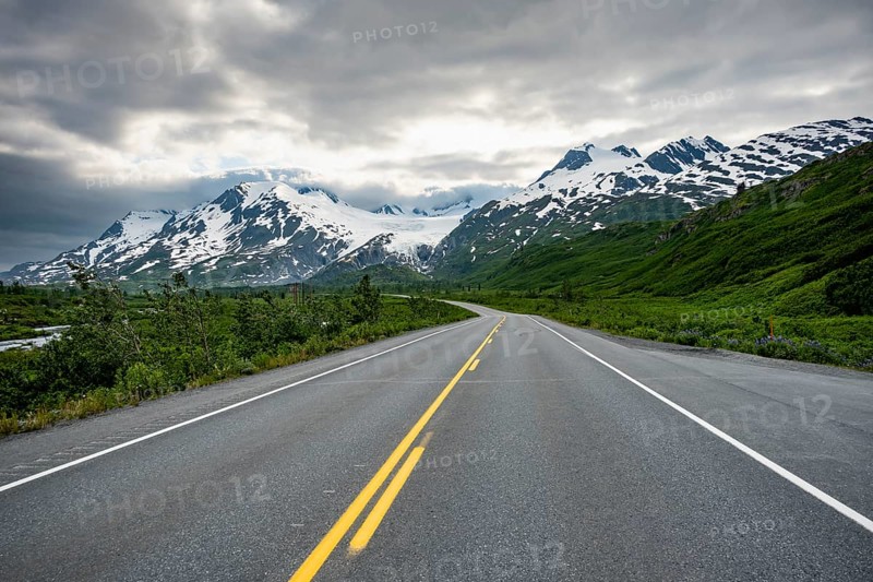 Road through mountain landscape, picturesque landscape with Worthington glacier, dramatic cloudy sky, Richardson Highway, Alaska, USA