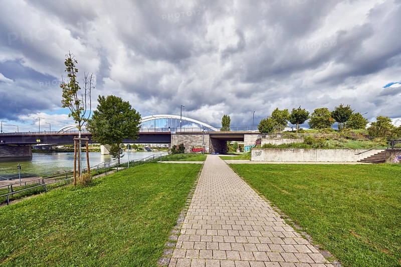 Beatus-Rhenanus bridge, pedestrian and tram bridge, architect Marc Barani, Rhine river, border between Germany and France, border river, park, trees, grass, paths, partly cloudy blue sky, cumulus clouds, cumulus congestus clouds, Kehl, Upper Rhine plain, Ortenau district, Baden-Württemberg, Germany