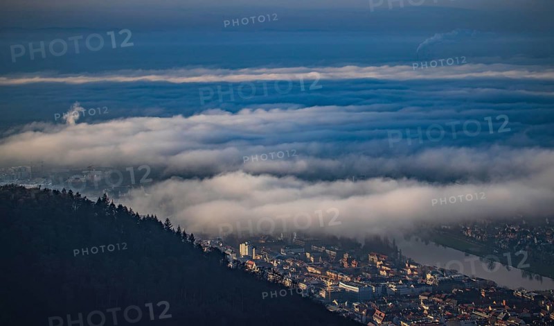 Aerial view of the city of Heidelberg on the Neckar, fog landscape of low-hanging clouds and fog fields floating and waving flat above the roofs of the city and the Neckar, Heidelberg, Baden-Württemberg, Germany
