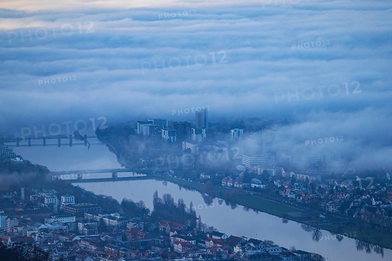 Aerial view of the city of Heidelberg on the Neckar, fog landscape of low-hanging clouds and fog fields floating and waving above the roofs of the city and the Neckar, Heidelberg, Baden-Württemberg, Germany
