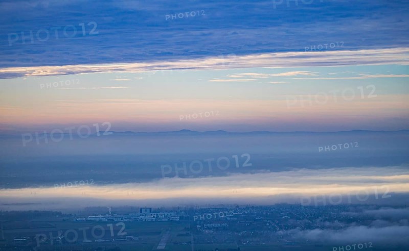 Aerial view of the city of Heidelberg on the Neckar, fog landscape of low-hanging clouds and fog fields floating and waving in the evening light above the Upper Rhine plain in the Rhine-Neckar metropolitan region with the mountains of the Palatinate Forest in the background, Heidelberg, Baden-Württemberg, Germany