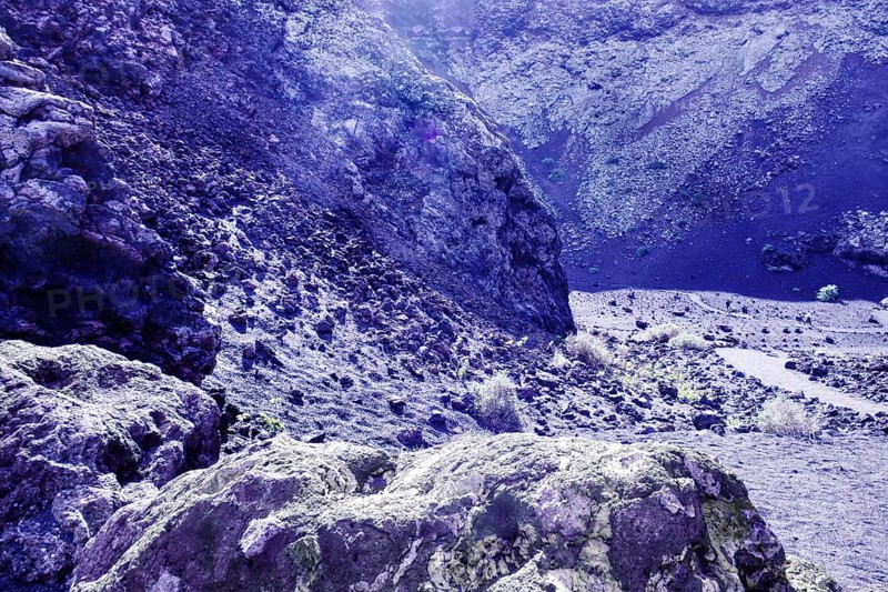 Dry, rocky terrain with rocky formations and soft lighting conditions, El Cuervo volcanic crater, Tinajo Lanzarote