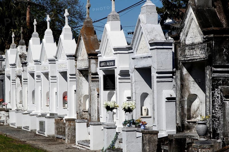 Row of white graves in Gothic style in a cemetery