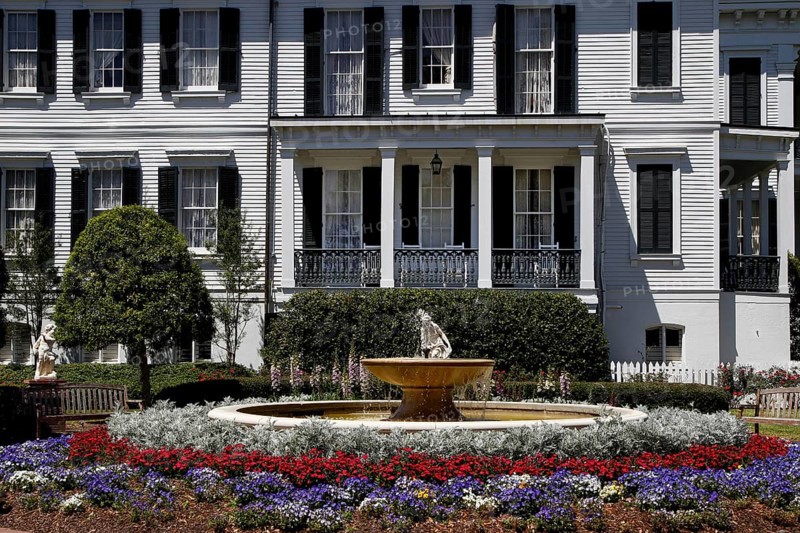 Nottoway Plantation mansion with decorative fountain and colorful flower bed, zero