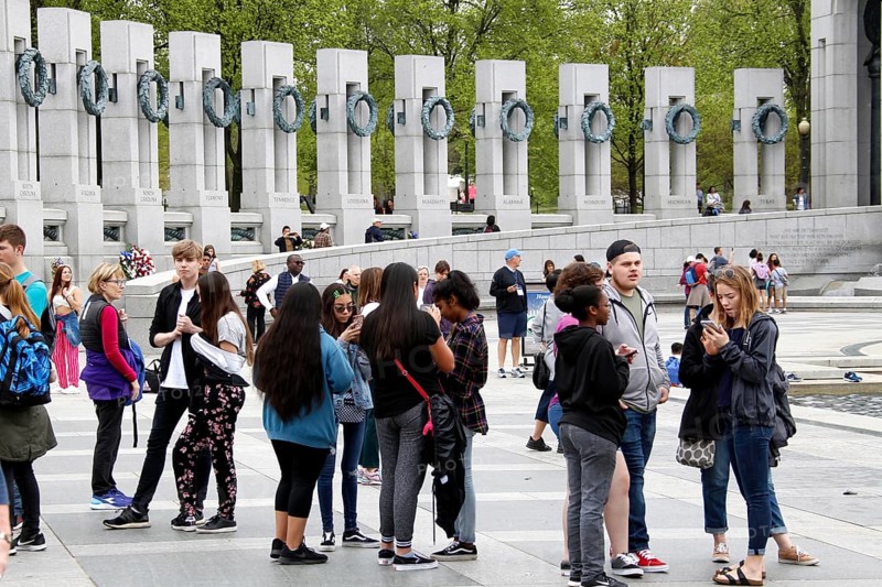 People group together at a memorial with tall pillars. The atmosphere is calm and respectful, Washington D.C, USA