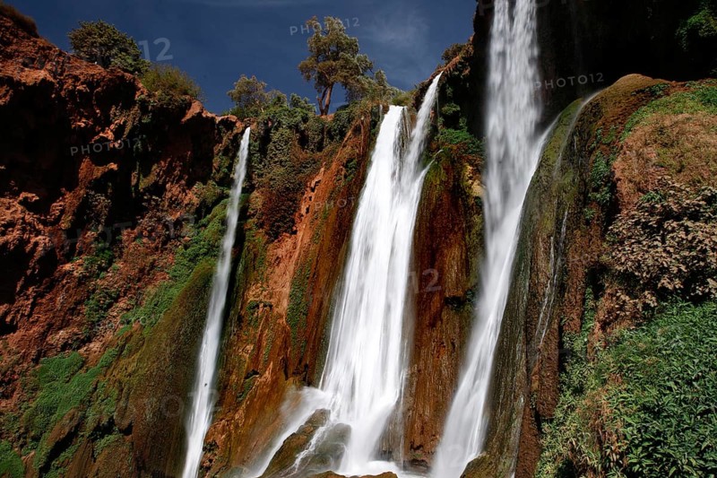 Majestic waterfalls of Ouzoud with thundering water surrounded by rocks and greenery, Ouzoud, Morocco