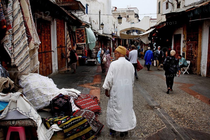 Bustling alley in the Medina of Rabat with people wearing traditional clothes, Rabat-Salé-Kénitra, Morocco