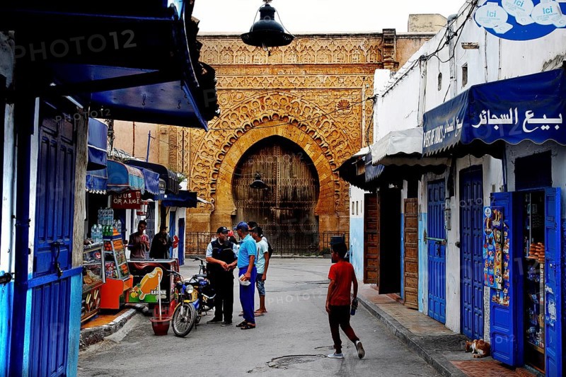 Historic street in the Kasbah des Oudaias with archway and blue facades, Rabat, Morocco