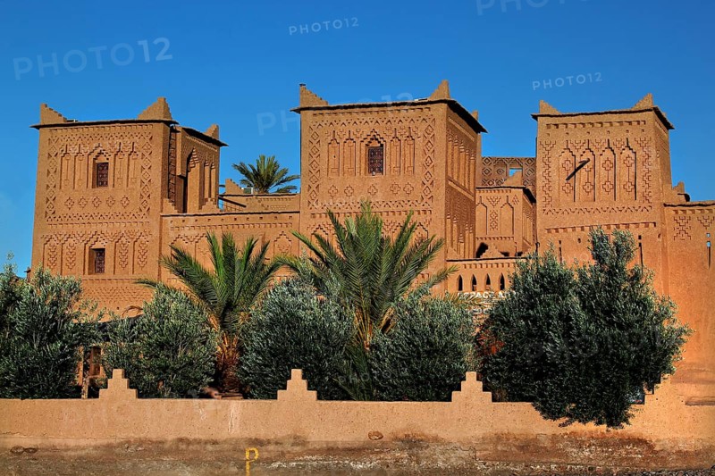 Kasbah Amerhidil with palm trees in the foreground and clear sky in Skoura, Skoura, Drâa-Tafilalet region, Morocco