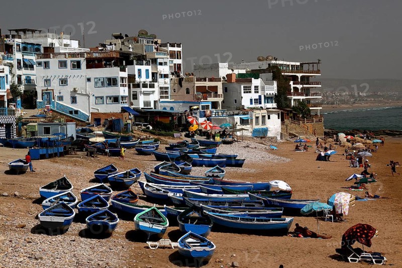 Fishing boats on Taghazout beach surrounded by buildings, Taghazout, Souss-Massa, Morocco