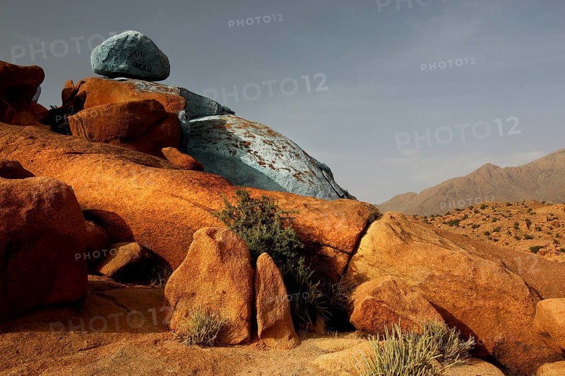 Blue and red rocks by Jean Verame in the desert landscape of Tafraoute, Tafraoute, Souss-Massa, Morocco