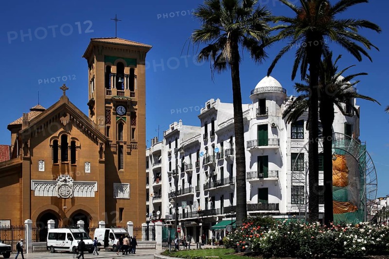 Historic buildings and church on Place Moulay el Mehdi, surrounded by palm trees, Tetouan, Morocco