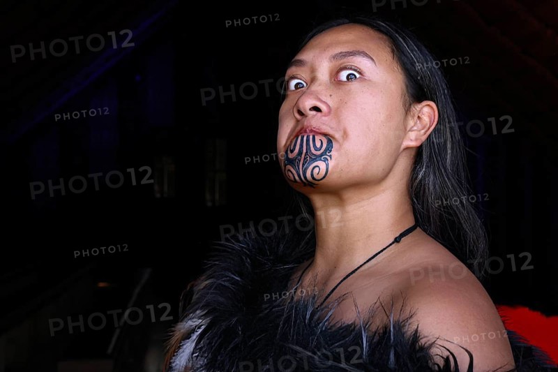 Woman with traditional face moko posing in traditional Maori clothing, Waitangi, New Zealand