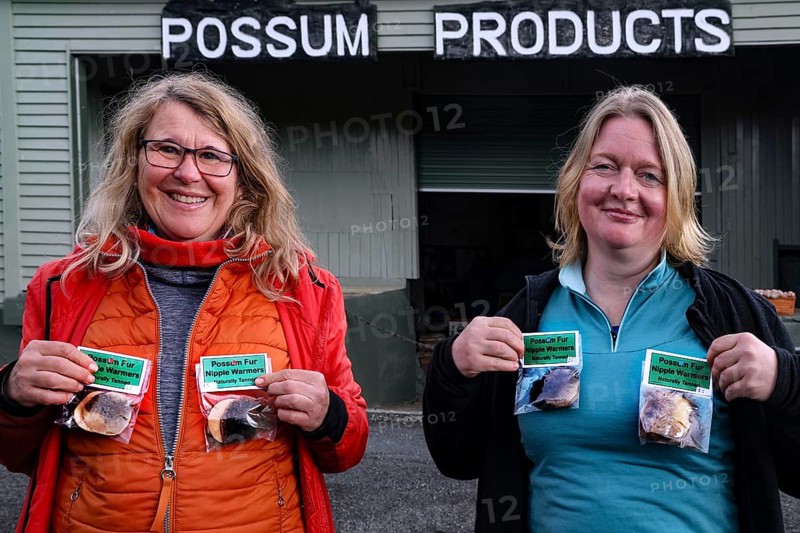 Two woman hold Possum products in front of the Possum Factory in Stratford, Stratford, New Zealand