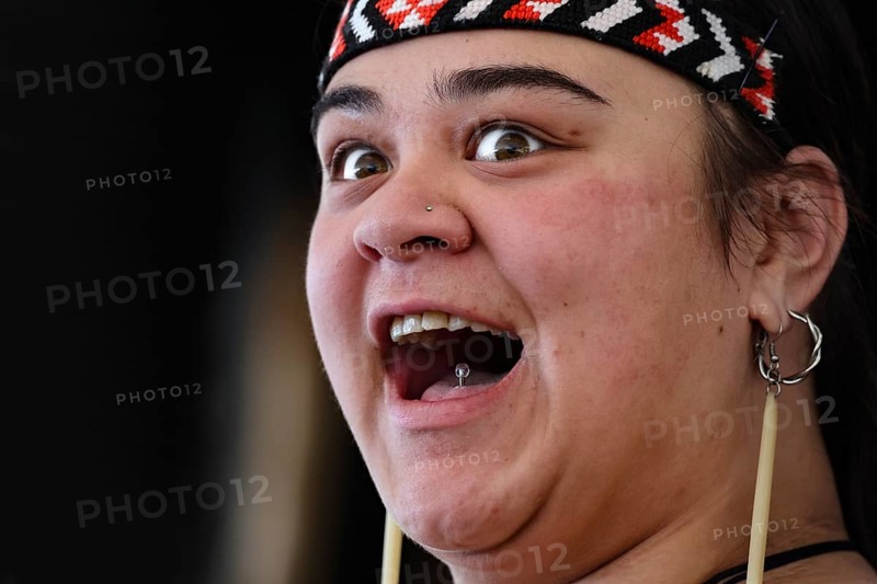 Woman with joyful facial expression in traditional dress, Rotorua, Whakarewarewa, New Zealand
