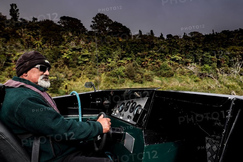 Man rides a motor boat along the Whanganui River through green nature, Whanganui River, Manawatu-Wanganui, New Zealand