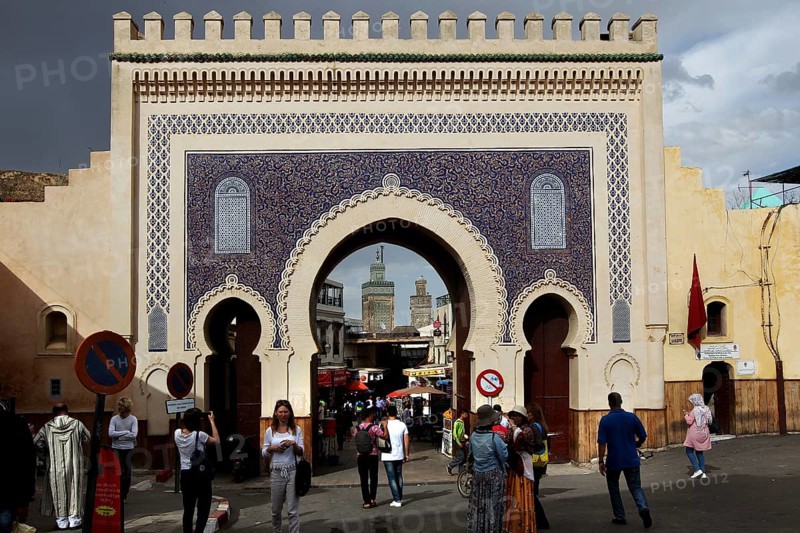 Bab Boujeloud in Fez with traditional mosaics and numerous passers-by, Fez, Fez el Bali, Morocco