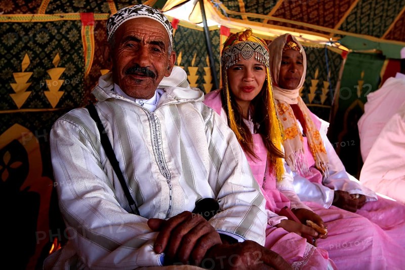 Traditional clothing and cultural atmosphere in the participant tent at the Fête des Roses, El Kelâa m'Gouna, Drâa-Tafilalet, Morocco
