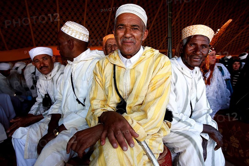 Men in traditional clothing in the participant tent during the Fête des Roses, El Kelâa m'Gouna, Drâa-Tafilalet, Morocco
