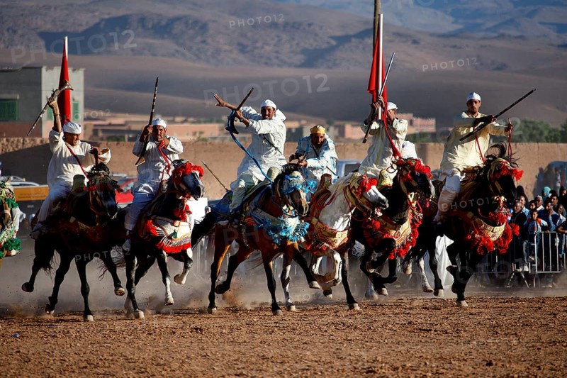 Committed riders cheer about the remarkable collaboration at the traditional Fantasia equestrian spectacle, El Kelâa m'Gouna, Morocco