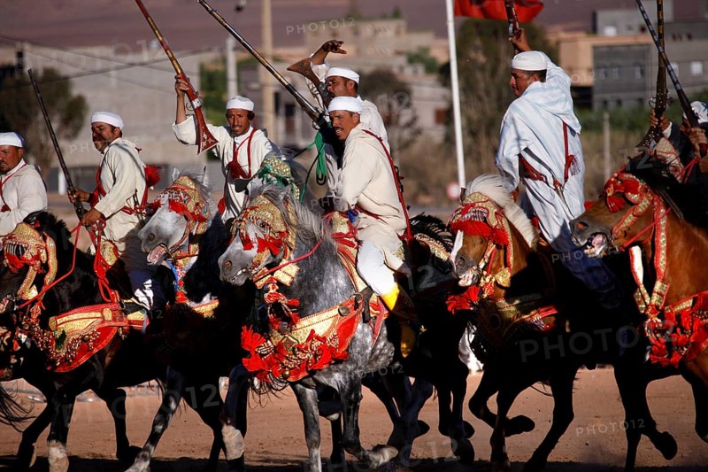 Equestrian group in traditional Moroccan costumes presents military choreographies on horses, El Kelâa m'Gouna, Morocco