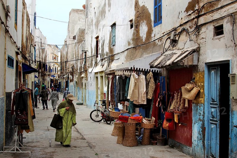 Shopping street with traditional shops and clothing displays in the old town, Essaouira, Marrakesh-Safi, Morocco