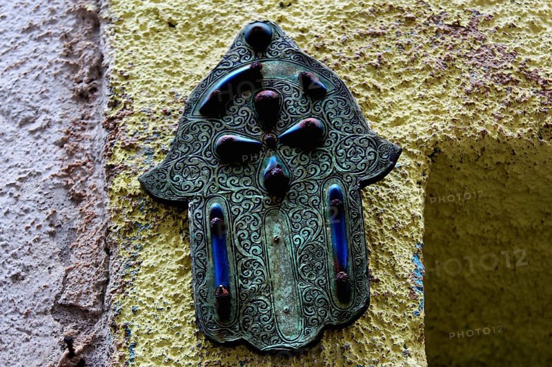 Hamsa hand relief as a decorative element on a wall in Essaouira, Essaouira, Morocco