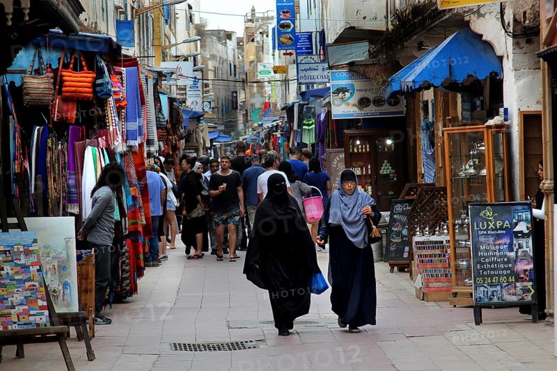 Bustling market street in Essaouira souk with many passers-by, Essaouira, Morocco