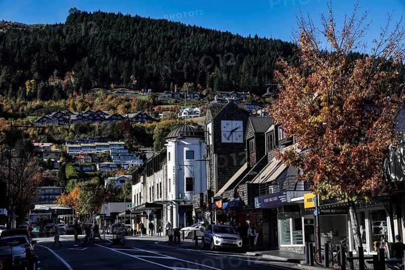 Bustling street in Queenstown lined with picturesque buildings and trees, Queenstown, New Zealand