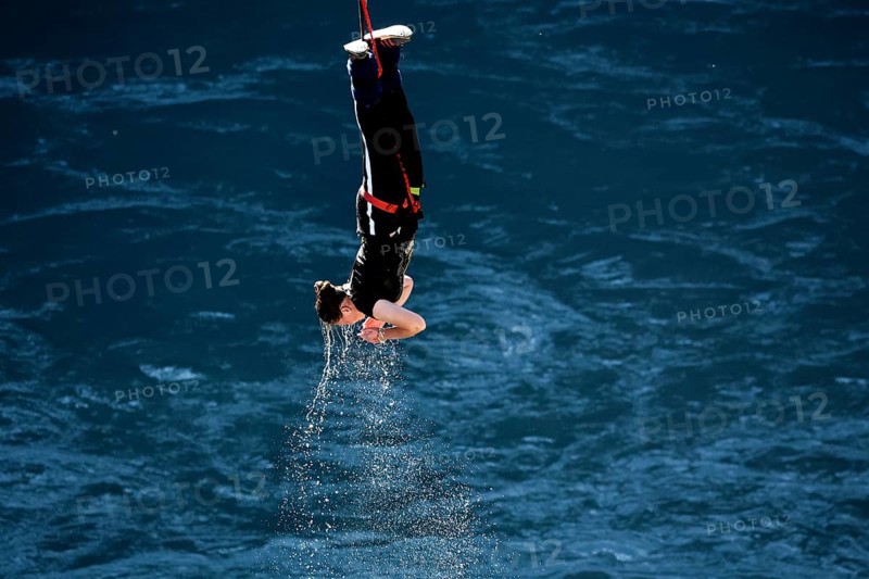 Jumpers diving headfirst into water from lofty heights, Queenstown, Otago, New Zealand