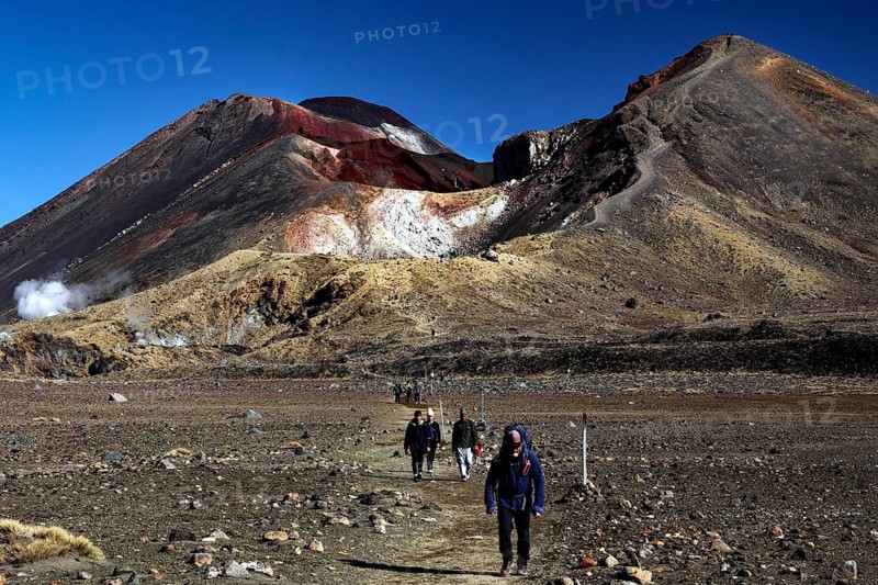 Hikers on Tongariro Alpine Crossing with views of Mount Tongariro and Mount Ngauruhoe, Tongariro National Park, North Island, New Zealand