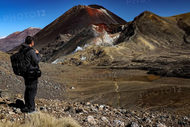 Hiker looking at Mount Ruapehu, Tongariro and Ngauruhoe, Tongariro National Park, North Island, New Zealand