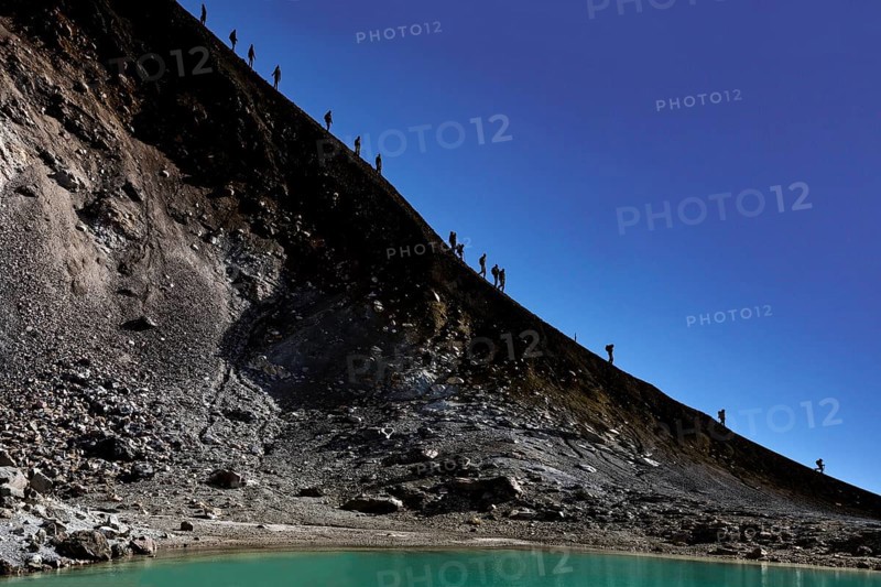 Descent along a steep crater trail at Mount Ngauruhoe under clear skies, Tongariro National Park, New Zealand