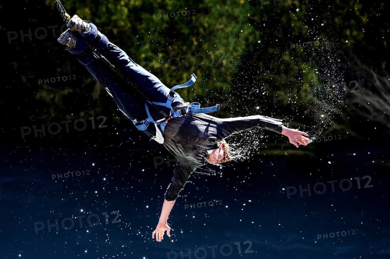Jumpers bungee jumping touches the water of the Kawarau River, Queenstown, Kawarau Bridge, New Zealand