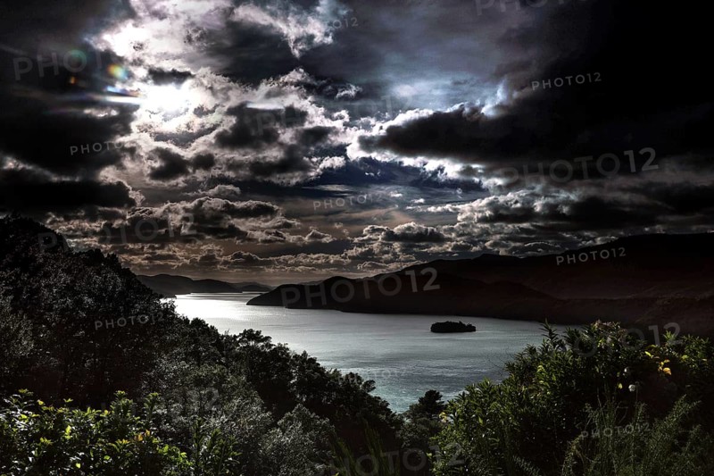 Dramatic clouds over a nighttime waterscape, Queen Charlotte Sound, Marlborough, New Zealand