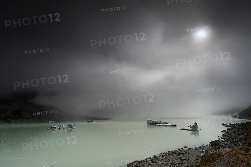 Night view of a glacial lake under cloudy sky in Aoraki National Park, Mt Cook, Hocker Valley Track, New Zealand