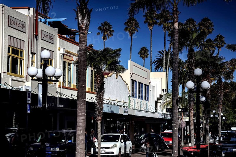 Street scene with art deco buildings and palm trees on a sunny day, Napier, Hawke's Bay, New Zealand