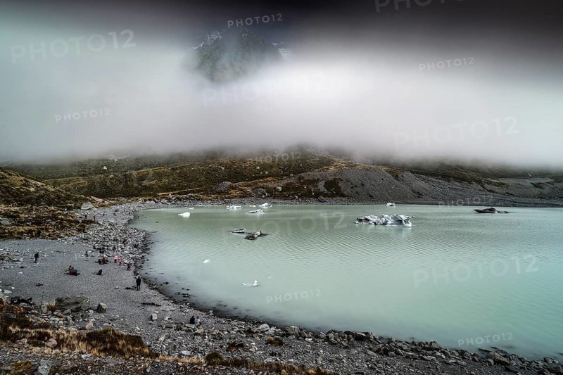 Glacial lake in misty Aoraki Mt Cook National Park with rugged shores, Mt Cook, Hocker Valley Track, New Zealand
