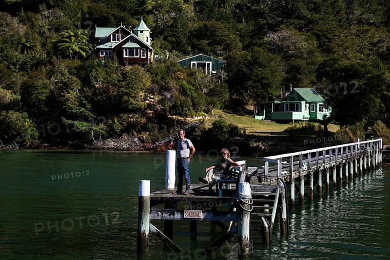 Timber house and pier on quiet Pelorus Sound, part of the mail delivery